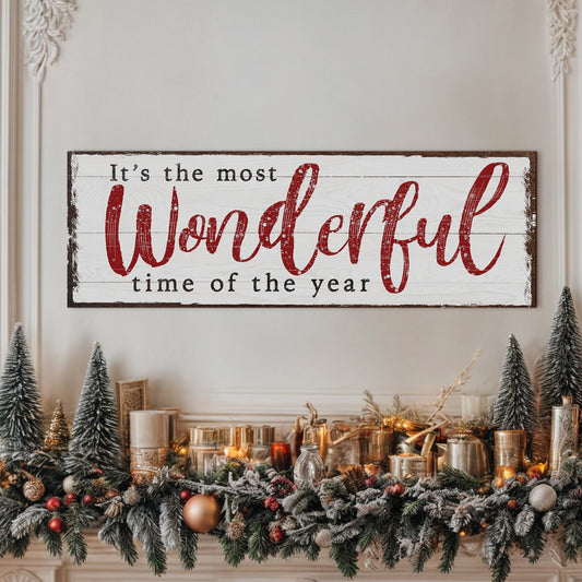 Decorative sign with 'It's the most Wonderful time of the year' text above a festive Christmas mantel.