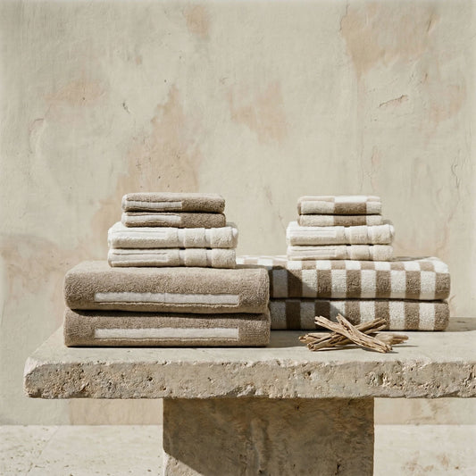 Stack of towels on a stone surface with a neutral background