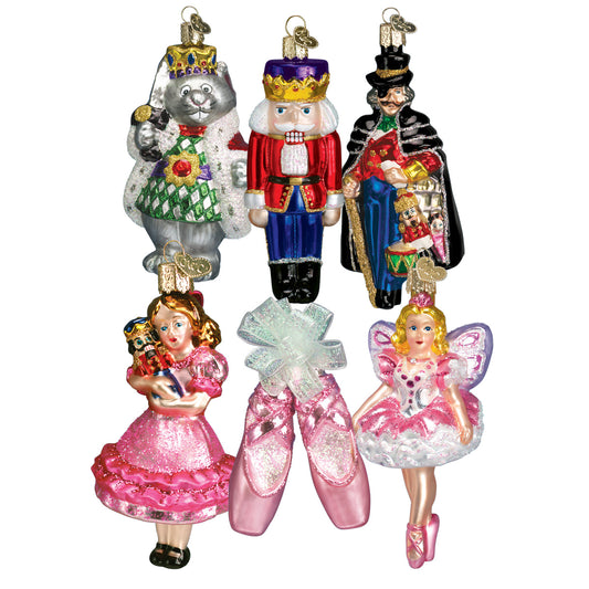 Set of colorful glass ornaments featuring characters from a fairy tale on a white background. Nutcracker, balerina slippers, toy soldier,  jester 