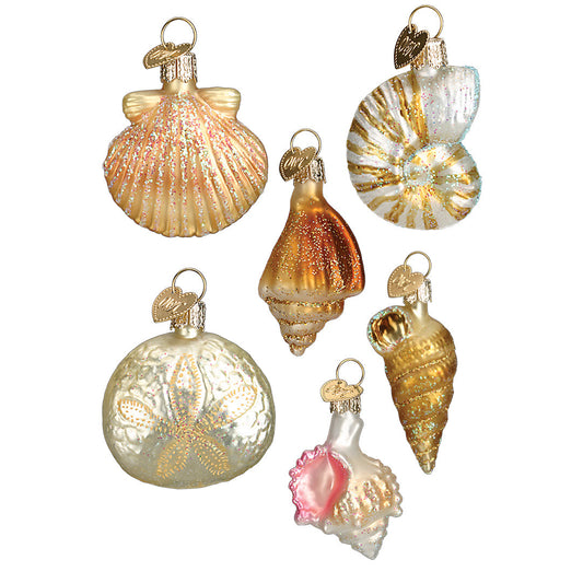 Set of decorative glass ornaments shaped like shells and balls on a white background