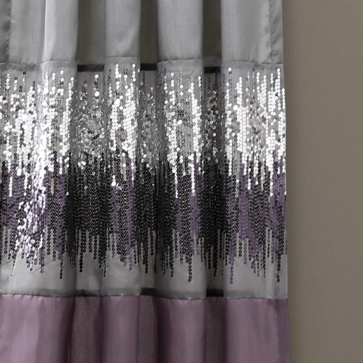 Sequined curtain with purple base on a plain background