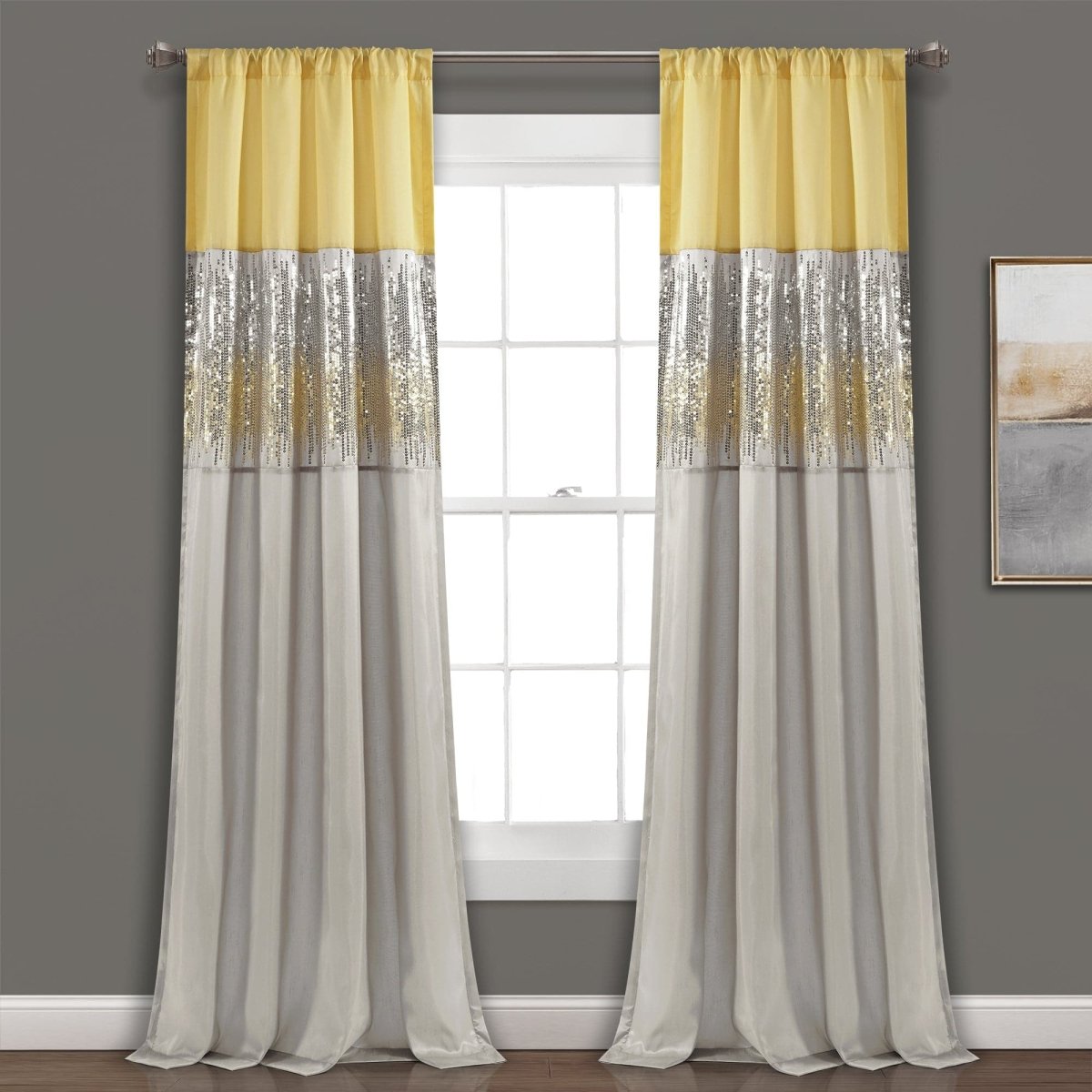 Yellow and gray striped curtains hanging in front of a window with a gray wall background. Shimmery and sparkly sequins curtain panel.