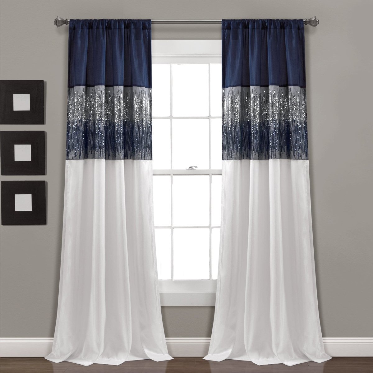 Navy and white striped curtains hanging in front of a window with a gray wall background. Shimmery and sparkly sequins curtain panel.