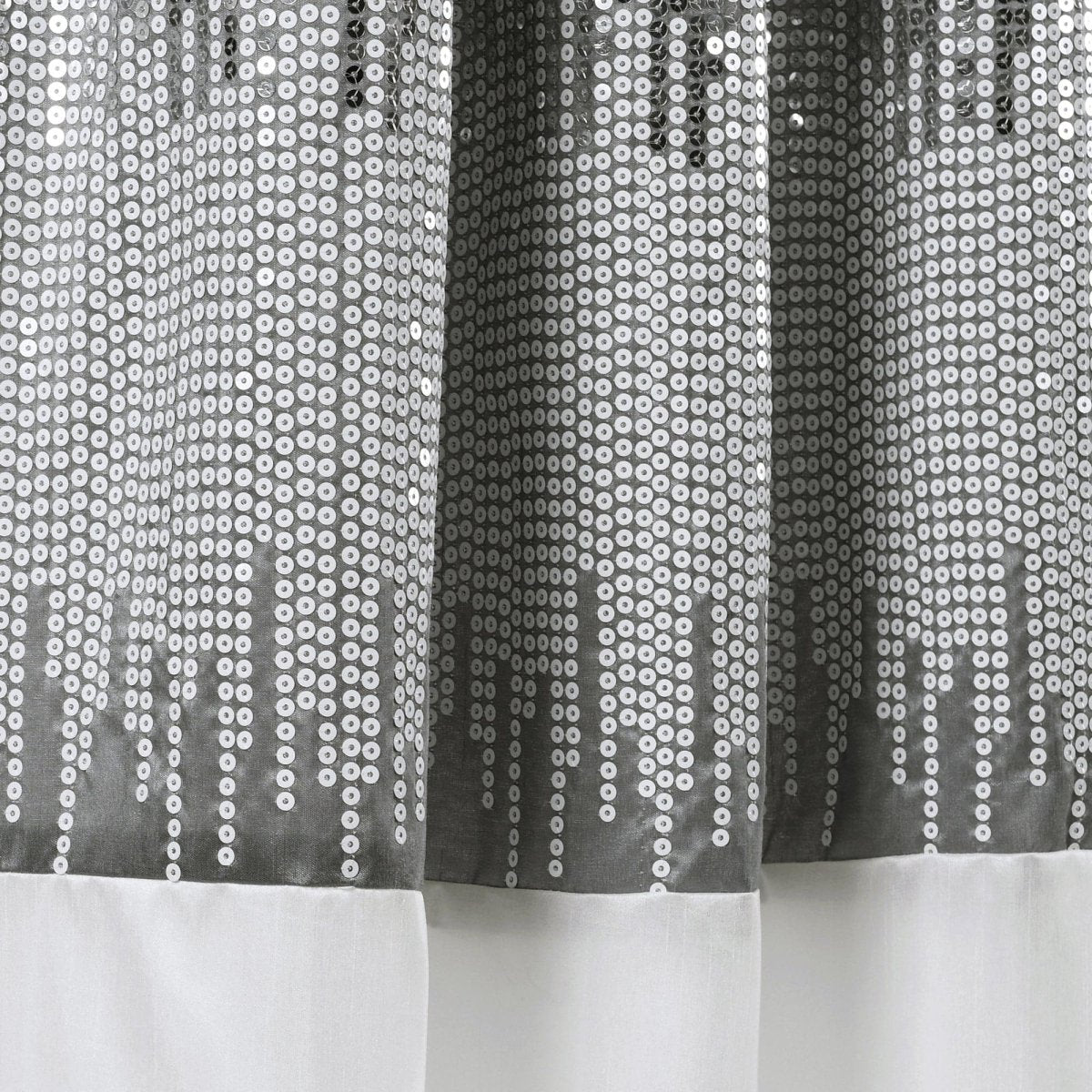 Sheer curtain with a pattern of small circles on a white background
