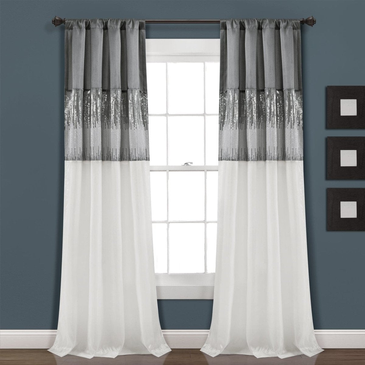White curtains with gray top panels in front of a window against a blue wall. Shimmery and sparkly sequins curtain panel.