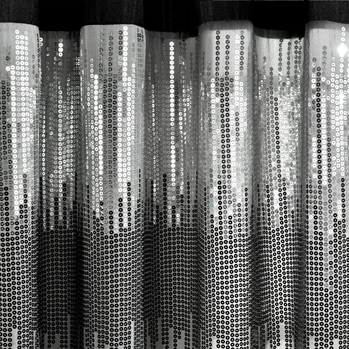 Close-up of a silver sequin curtain with a black background