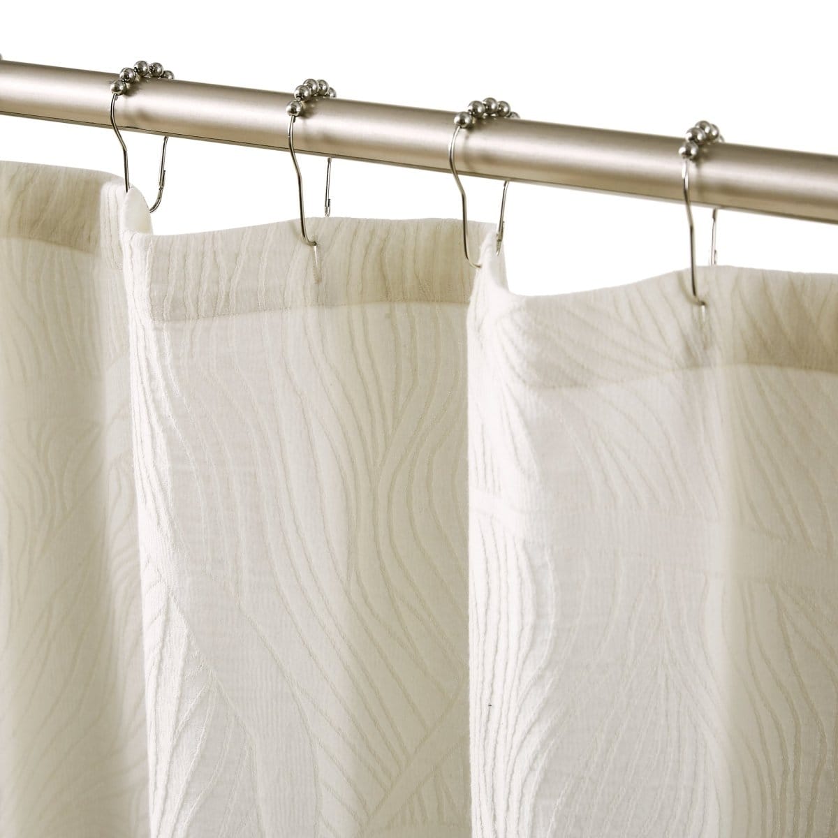 White textured shower curtain with silver hooks on a rod