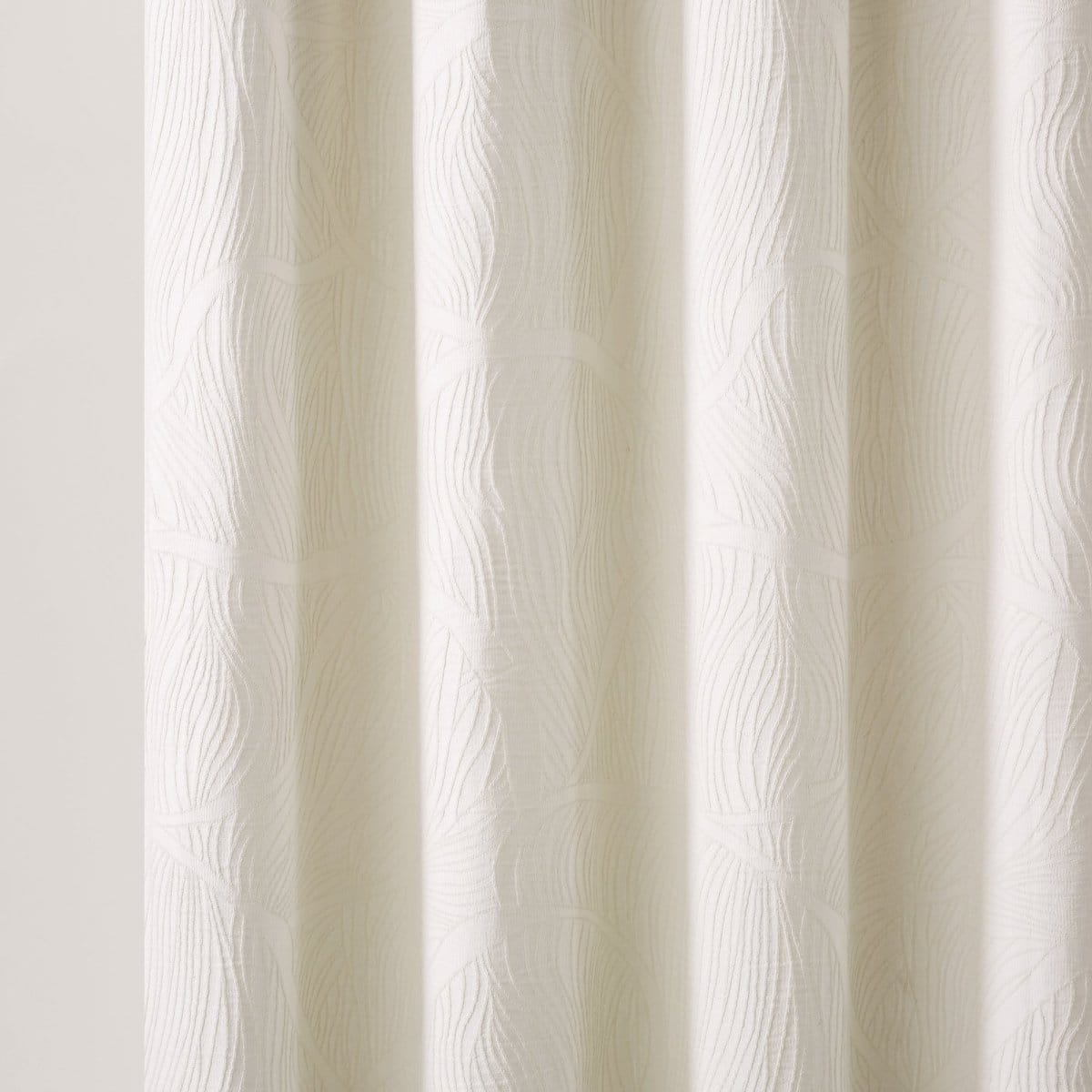 Textured white curtain panel on a light gray background
