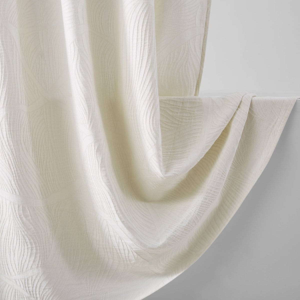 Close-up of a textured white fabric on a light gray background