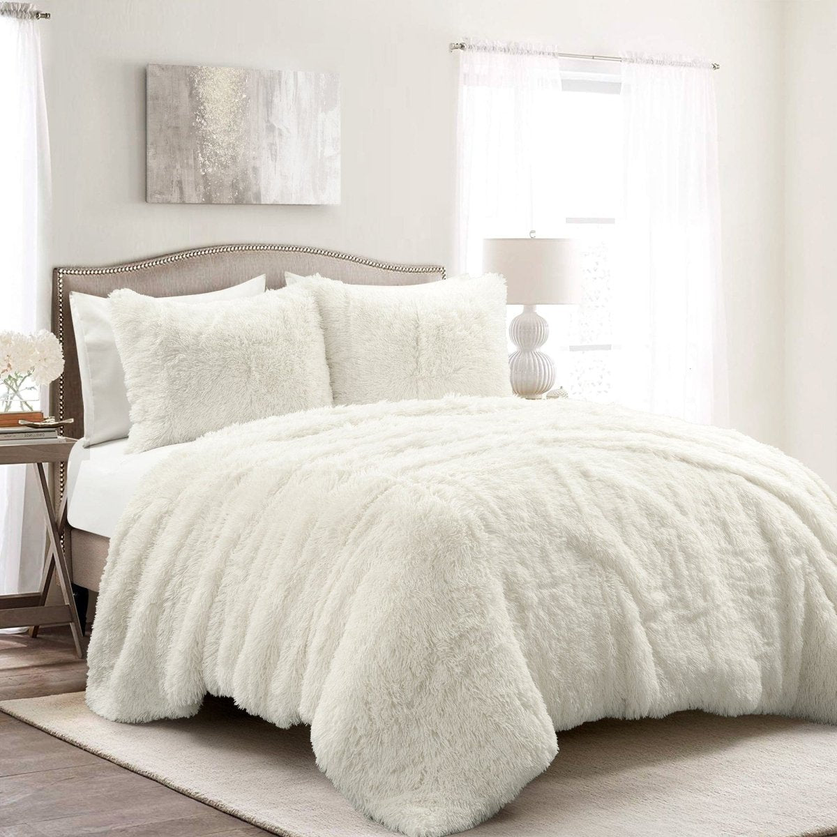 White fluffy comforter on a bed in a bedroom setting.Faux fur bedding bed set.