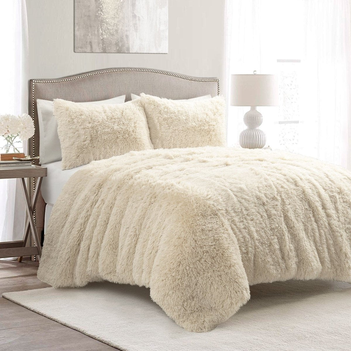 Beige fuzzy comforter on a bed in a bedroom setting. Faux fur bedding bed set.