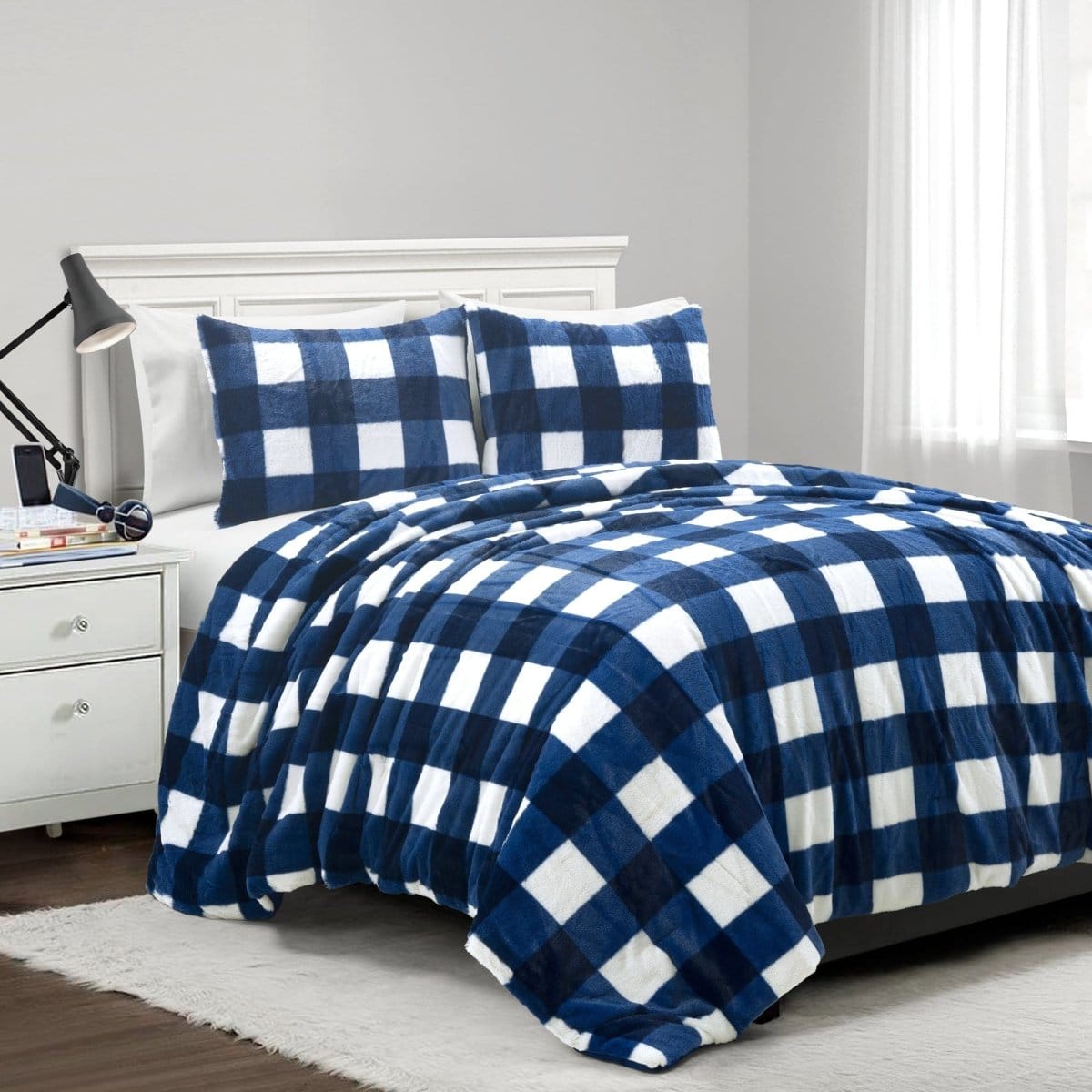 Blue and white checkered comforter set on a bed in a bedroom. Faux fur checkered comforter bed set.