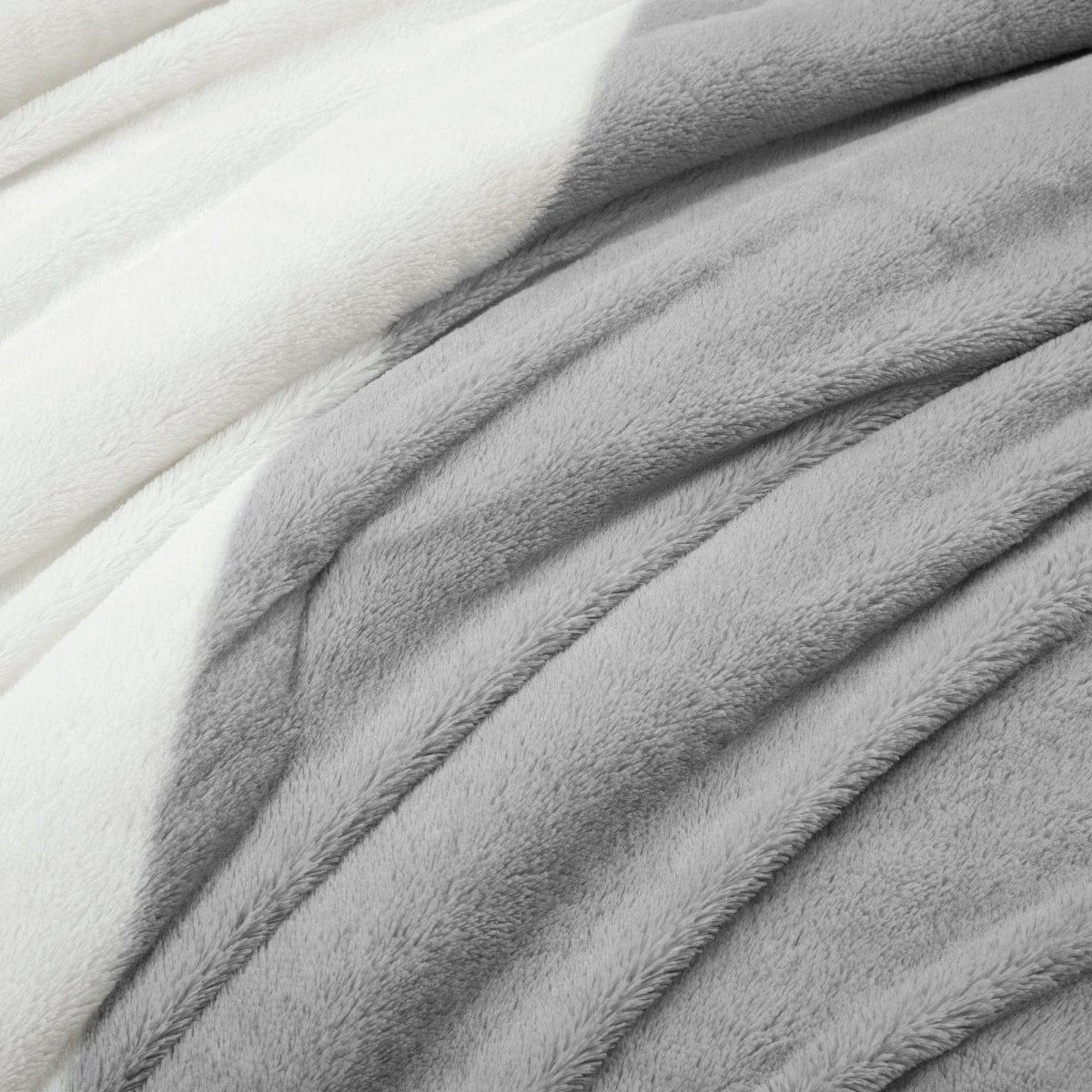 Close-up of gray and white fabric texture. Farmhouse Faux Fur Comforter Set - Ultra Soft Color Block Bedding | LushDecor
