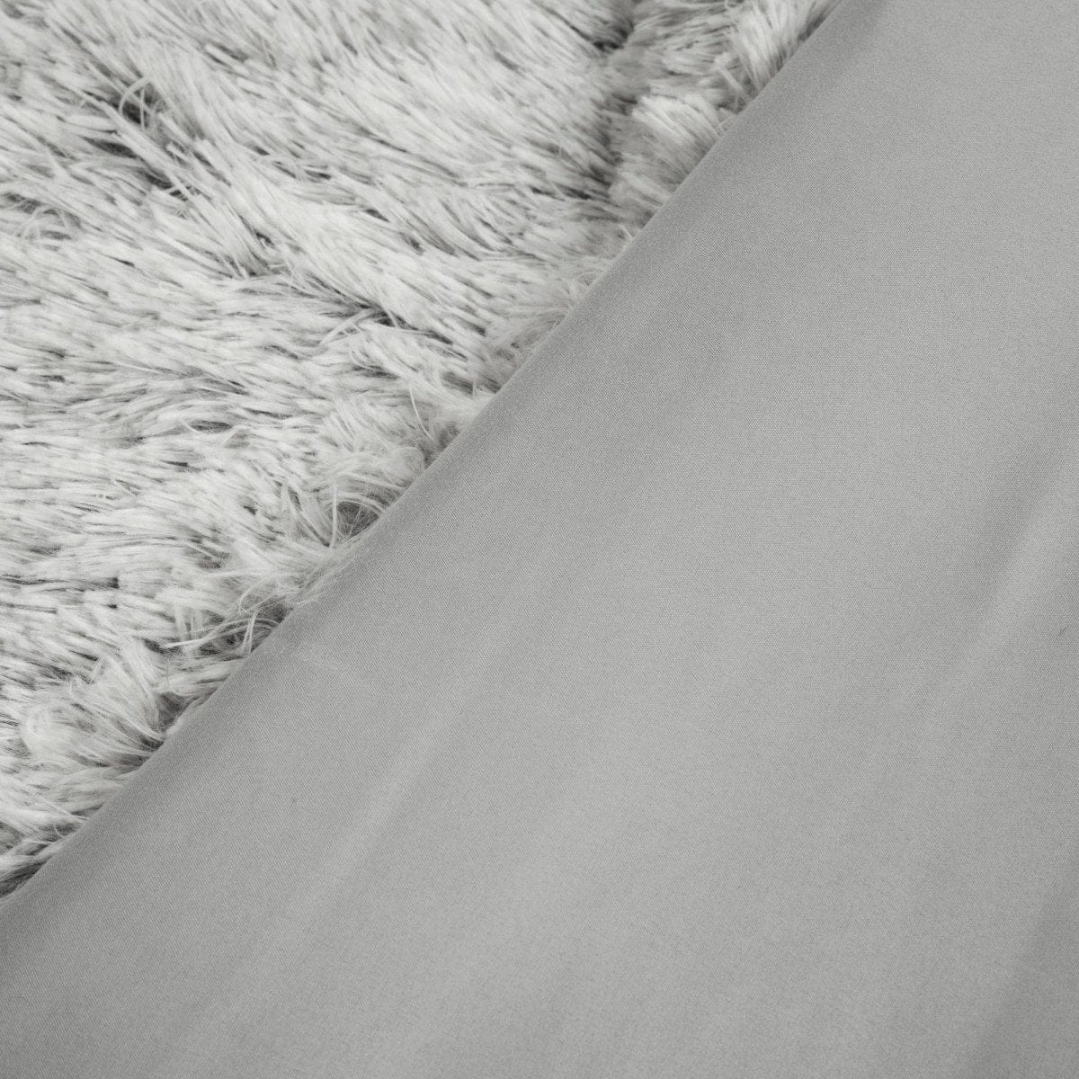 Close-up of gray fabric and textured gray surface. Ultra-soft two-tone faux fur comforter set by LushDecor. Complete bedding set with comforter & shams. Machine washable luxury. 8.5 lbs, all-season comfort.