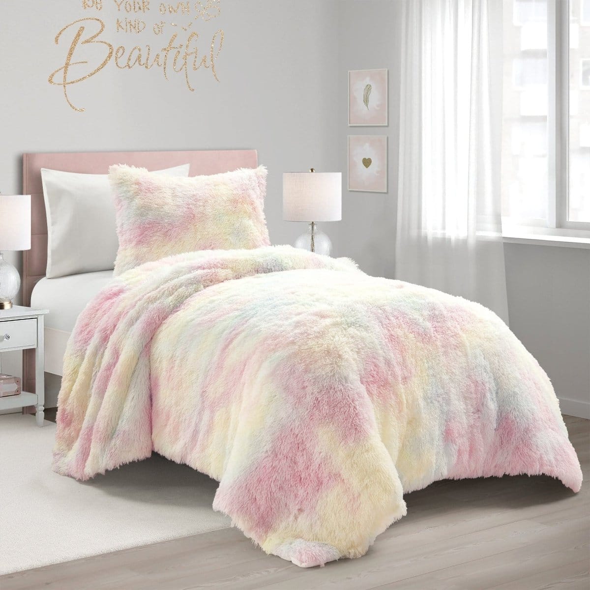 Bed with a colorful comforter in a bedroom setting. Pastel tie-dye comforter set on a bed with a pink headboard in a bedroom setting. Faux fur bedding. Girls.