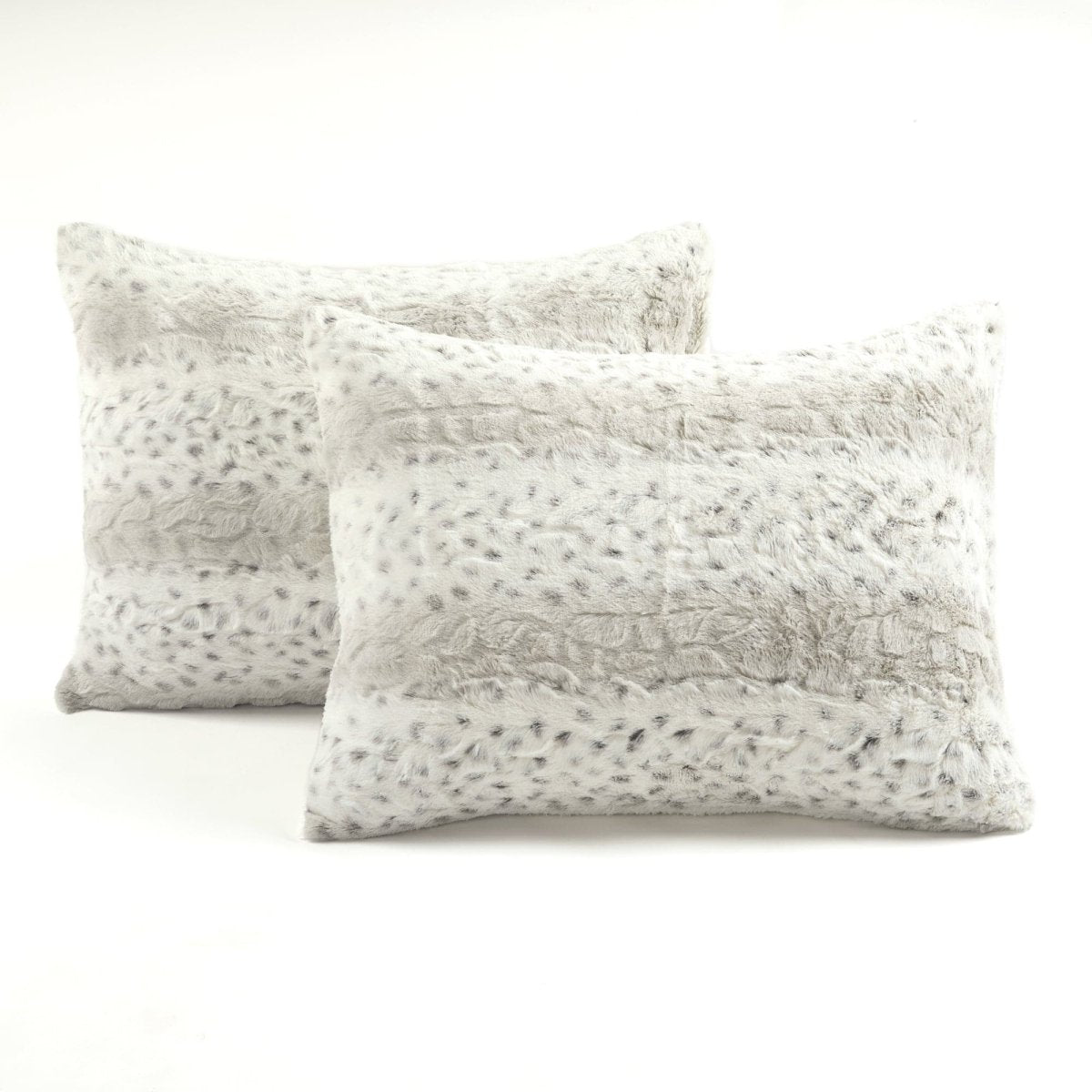 Two textured pillows on a white background.Leopard faux fur in color block stripe bedding
