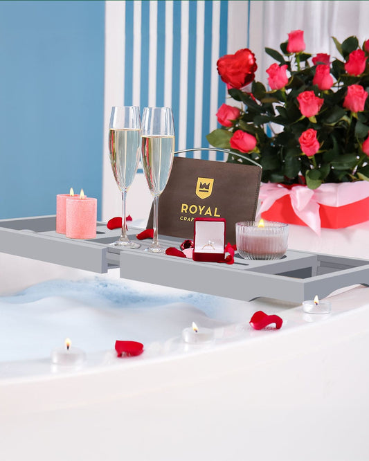 Valentine's Day gift setup with flowers, champagne, and jewelry box on bath caddy/ bath table. 