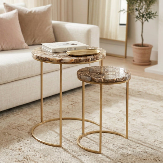 Set of two marble top side tables with gold metal frames on a white background