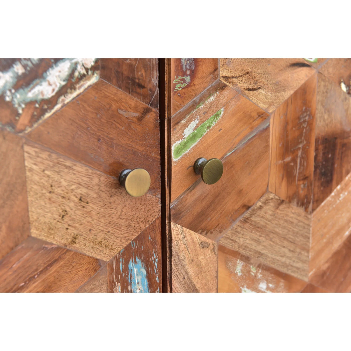 Close-up of a wooden cabinet with brass knobs on a white background