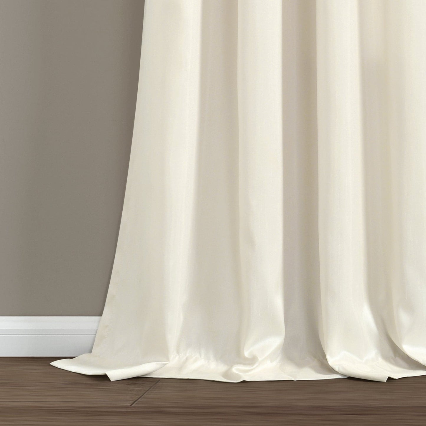 White curtain on a wooden floor with a neutral wall background
