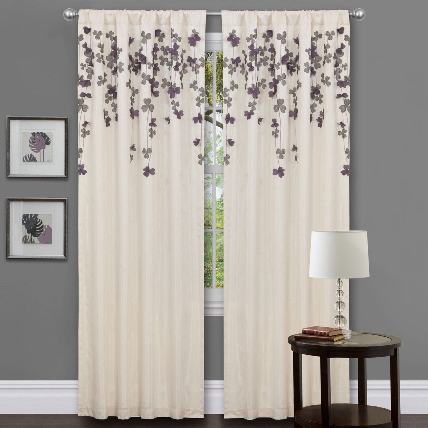 Beige floral curtains with a side table and lamp against a gray wall. floral drop embroidered curtain 