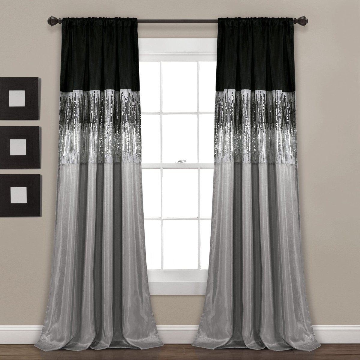 Black and gray striped curtains hanging in front of a window. Shimmery and sparkly sequins curtain panel.