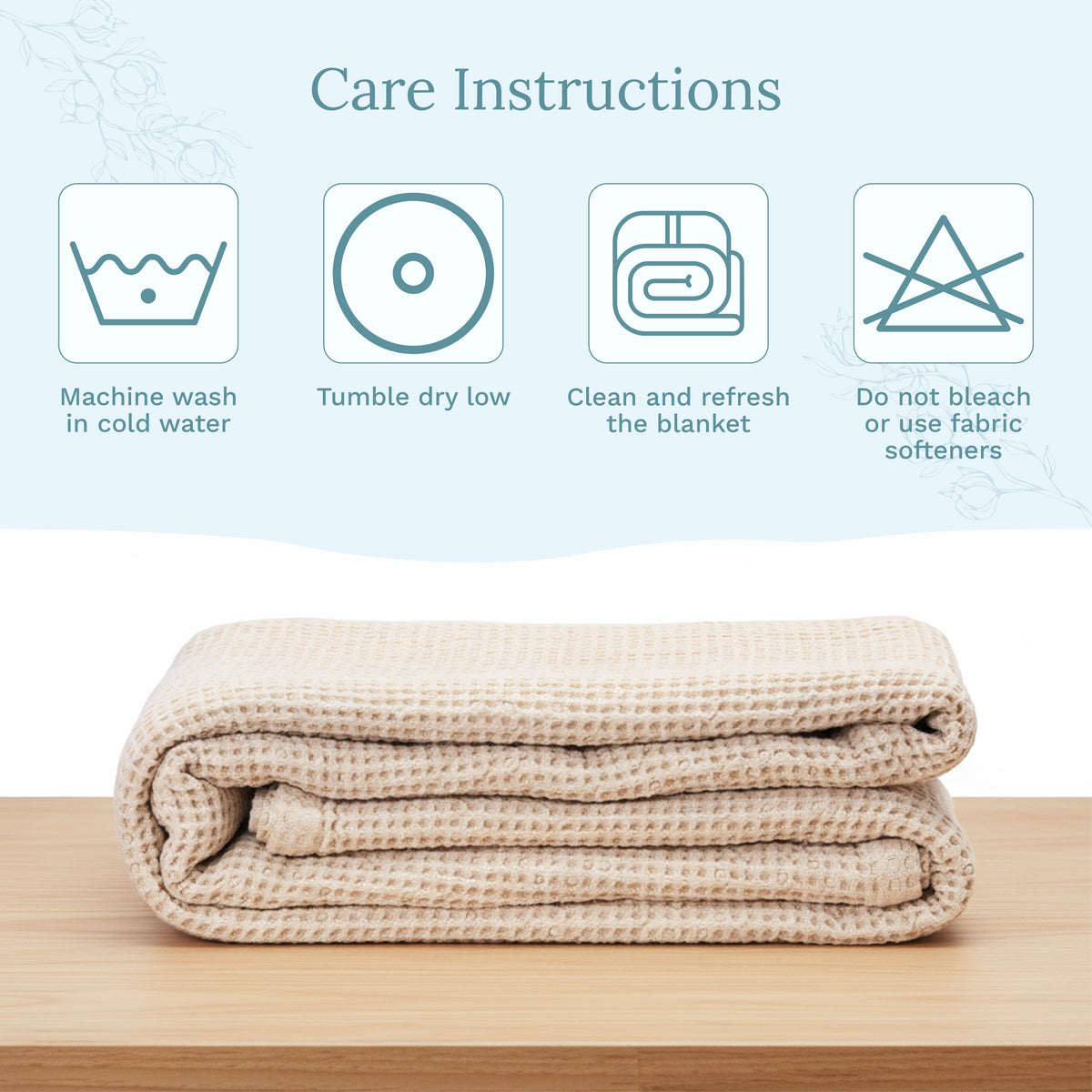 Folded beige blanket on a wooden surface with care instructions displayed above.