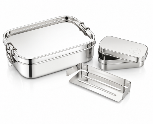 Set of silver metal lunch boxes and cutlery on a white background