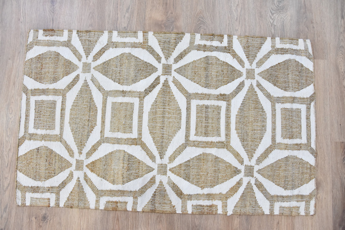 Patterned rug with geometric design on a wooden floor