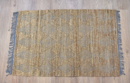 The Timbergirl handmade jute and cotton rug features a diamond pattern in grey and beige. Its rectangular shape and reversible braided construction bring texture and neutral color to your living space.

Made from 80% jute and 20% cotton, this hand-woven rug has a listed pile height of 0.25–0.5 inches.