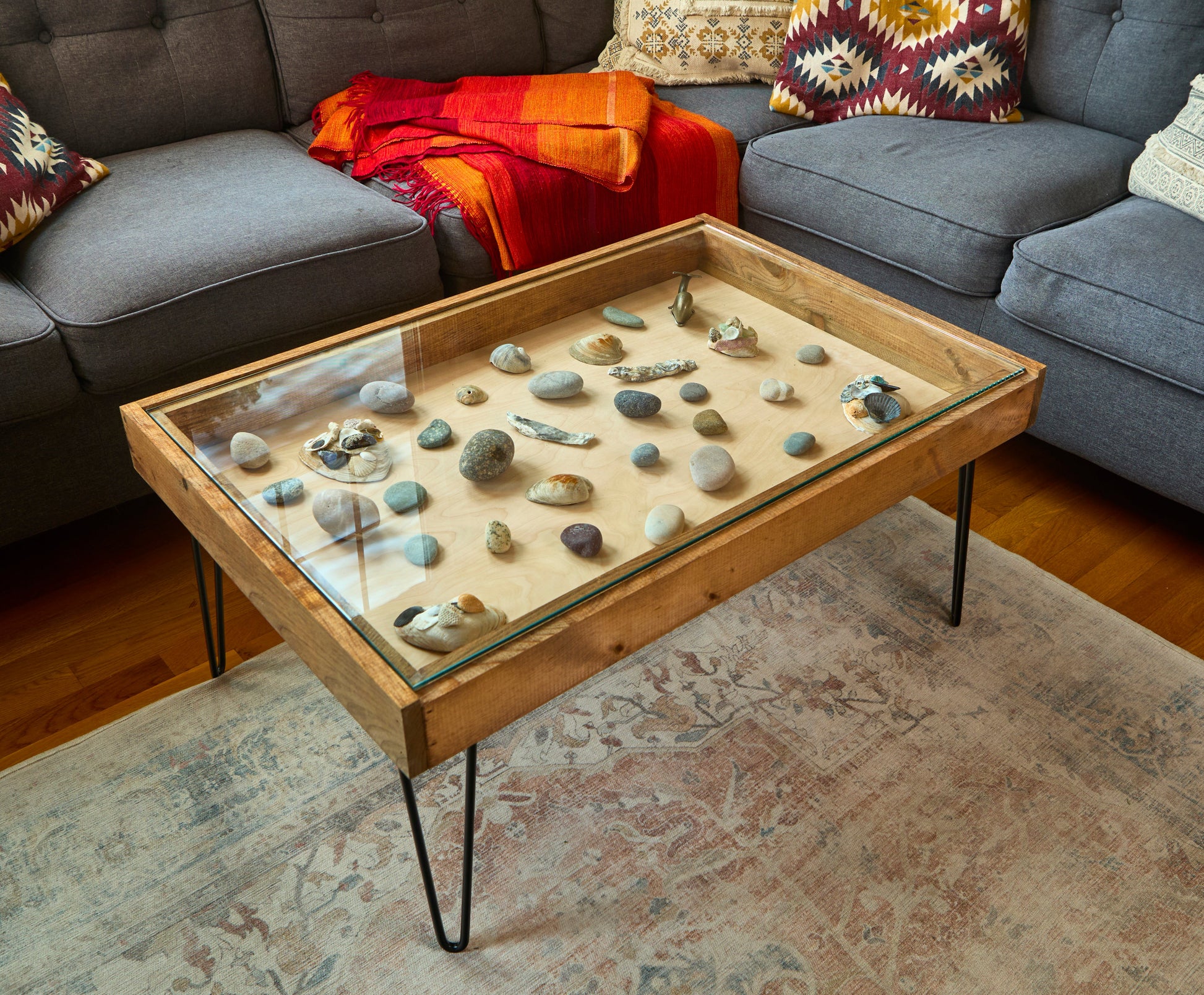 Coffee table with decorative stones in a living room setting