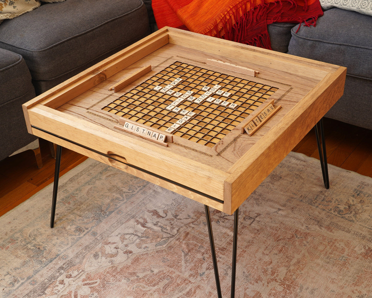 Wooden game board with crossword puzzle on a coffee table in a living room.