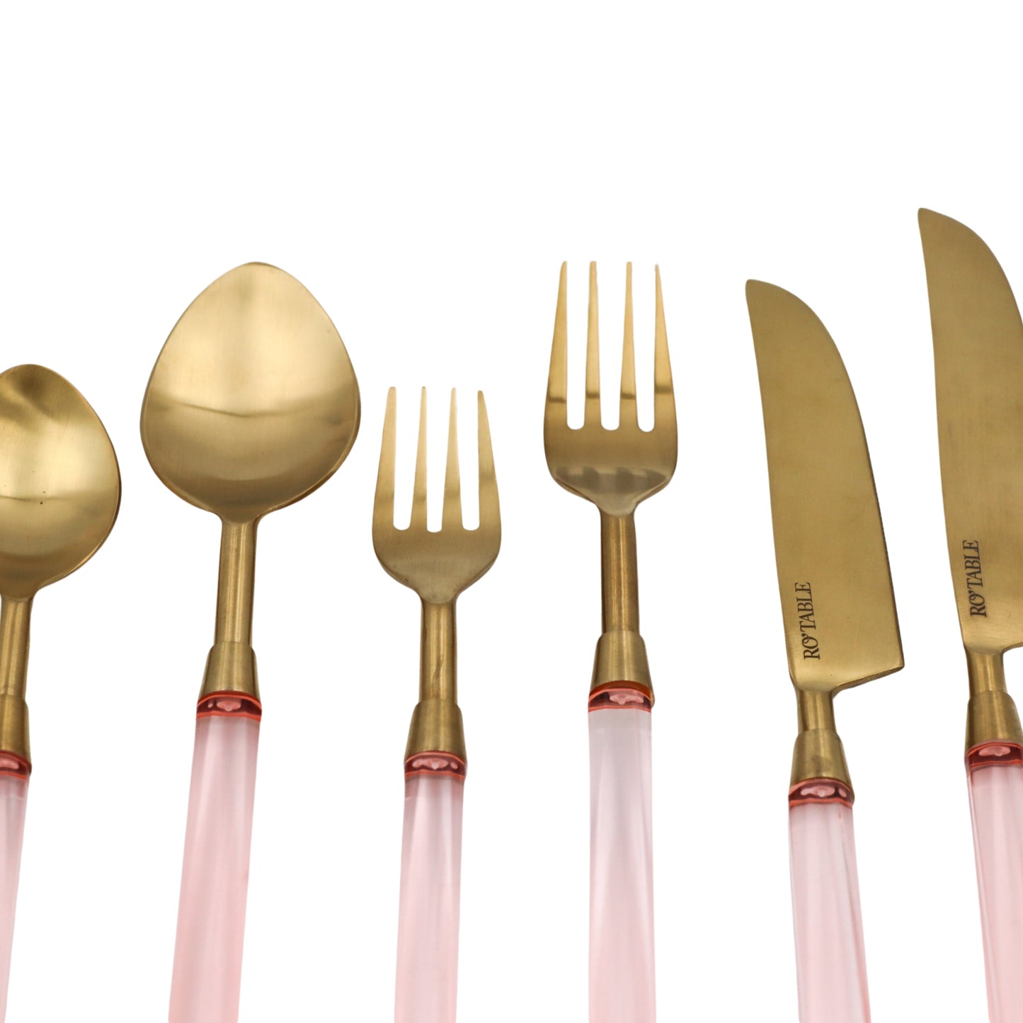 Gold cutlery set with pink handles on a white background