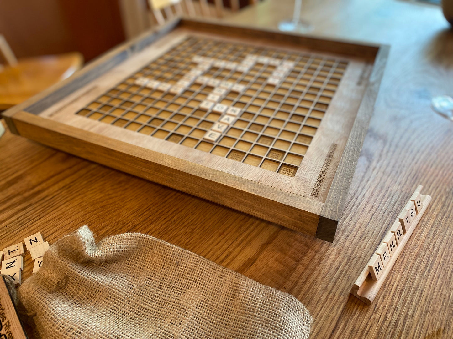 Wooden scrabble board with tiles on a wooden table