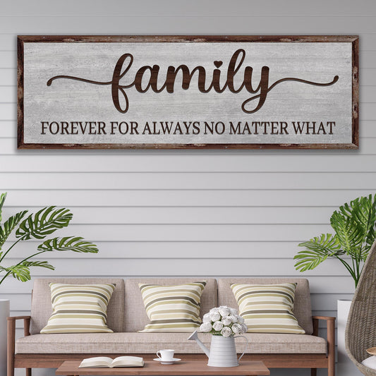 Wooden sign with 'family forever for always no matter what' text above a living room with a sofa and plants.