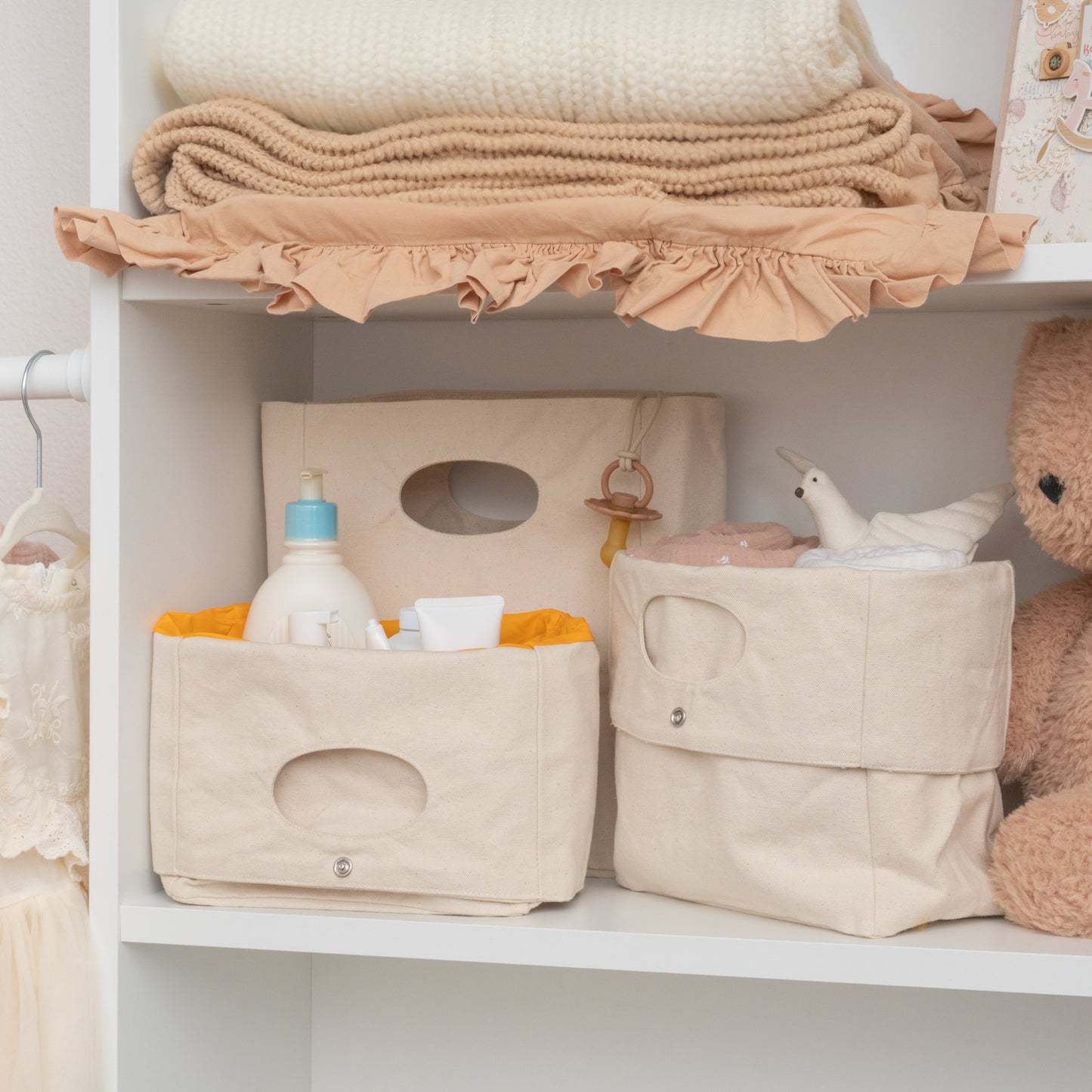 Shelving unit with storage bins, baby bottle, and toys in a neutral setting