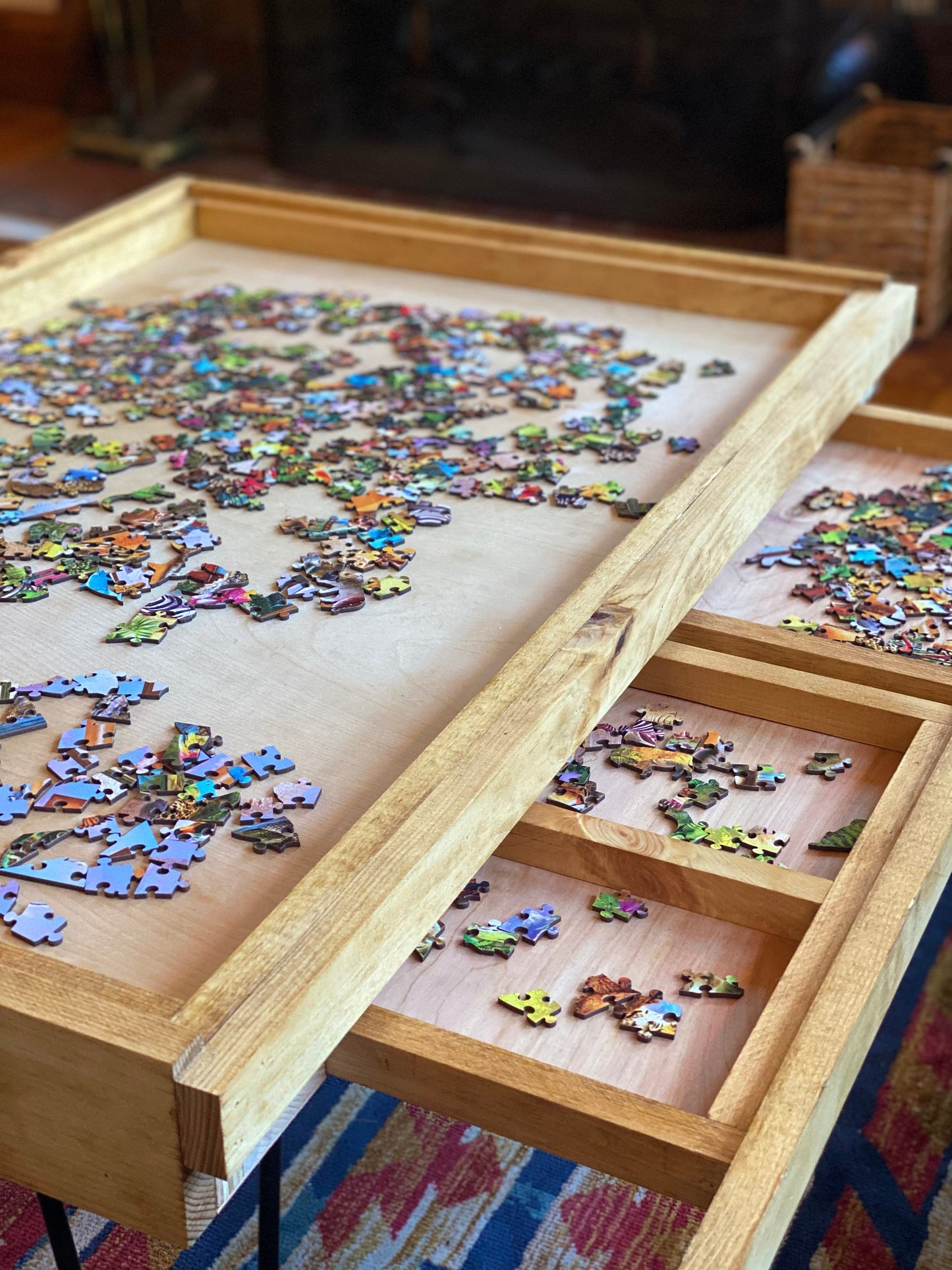 Jigsaw puzzle with missing pieces on a wooden tray with a drawer.
