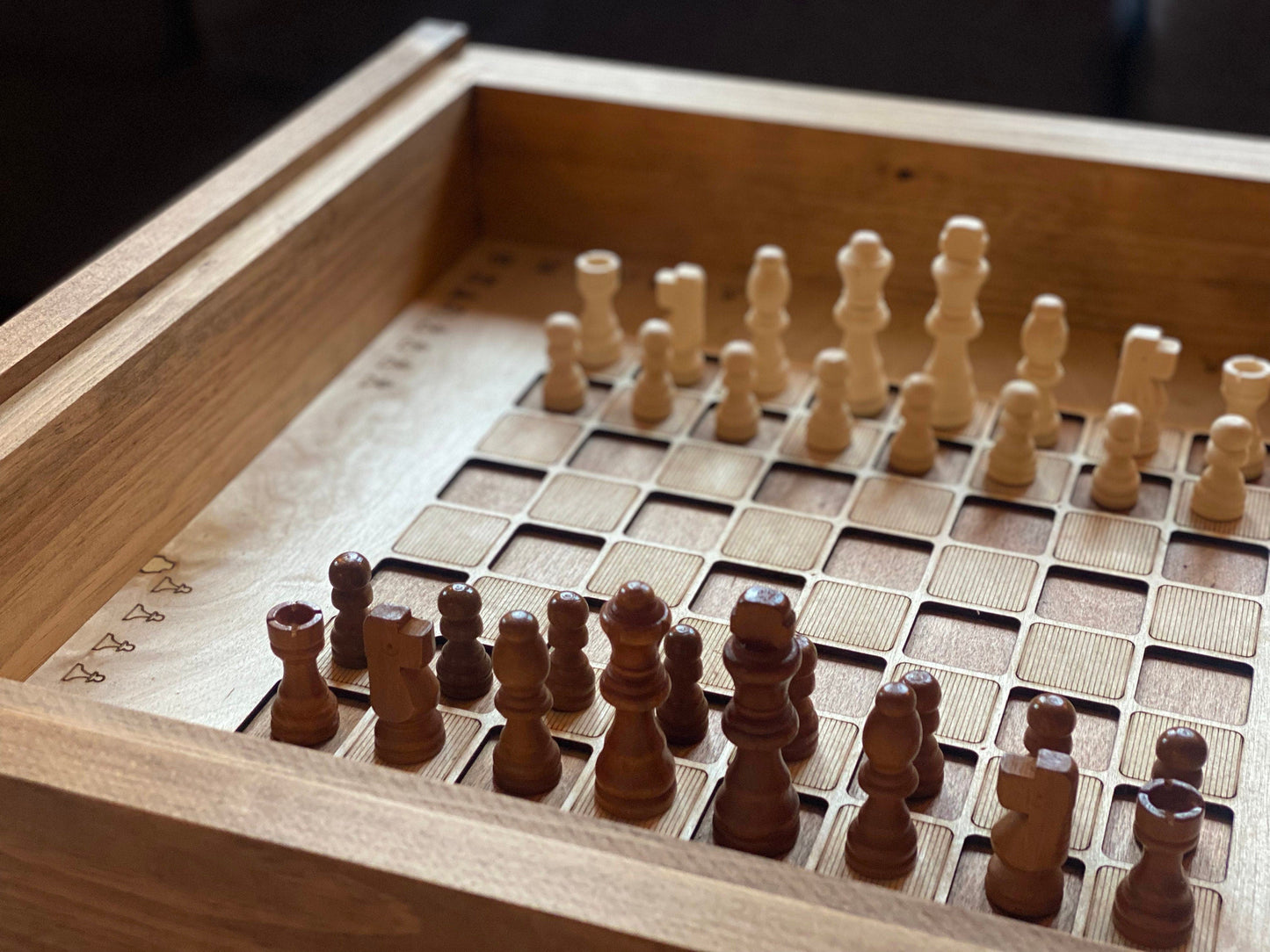 Wooden chessboard with pieces on a wooden surface