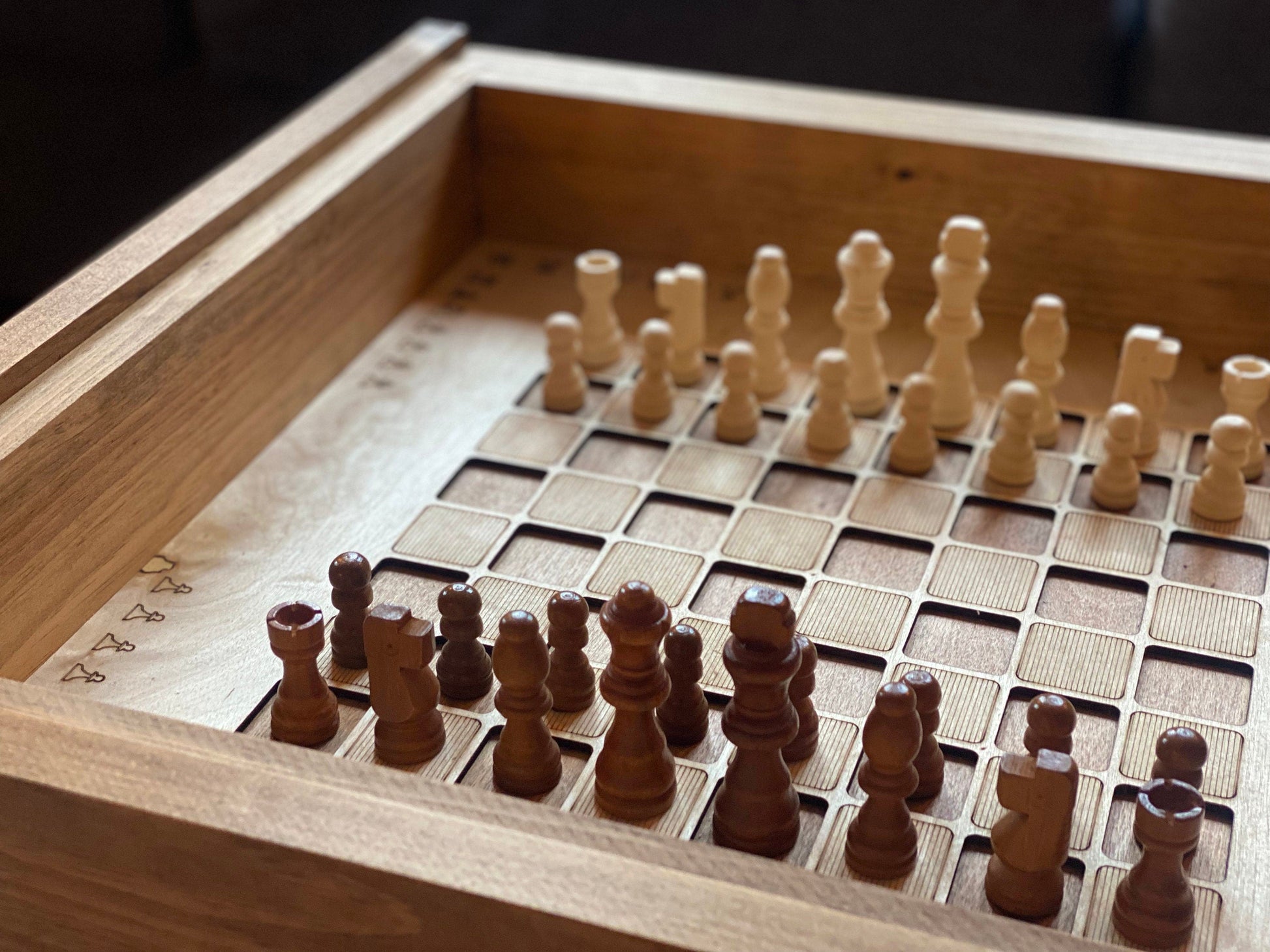 Wooden chessboard with pieces on a wooden surface