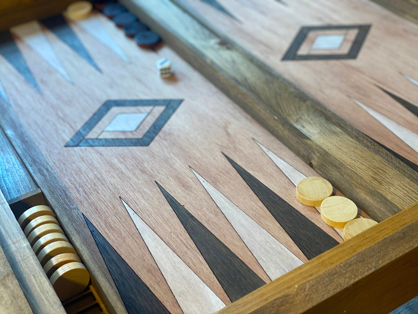 Close-up of a backgammon board with pieces and dice.