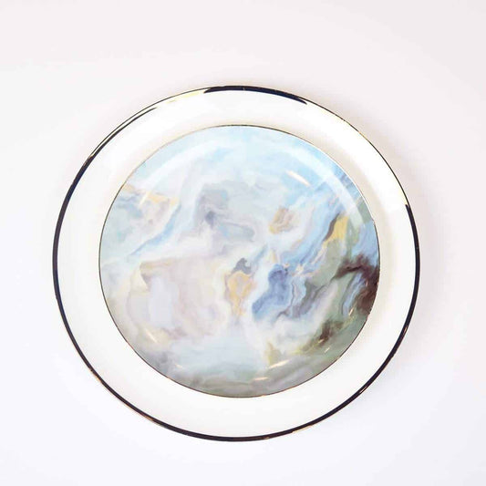 Round marble object with a silver frame on a white background