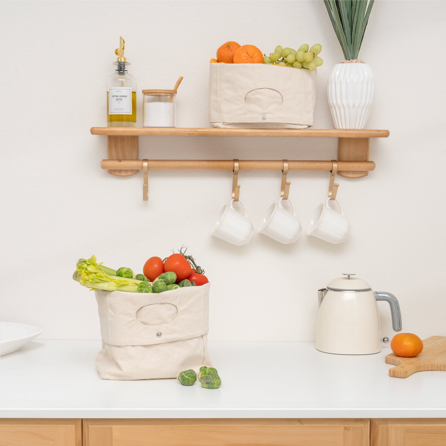 Kitchen with wooden shelf, fruit, vegetables, and kitchenware on a white countertop.