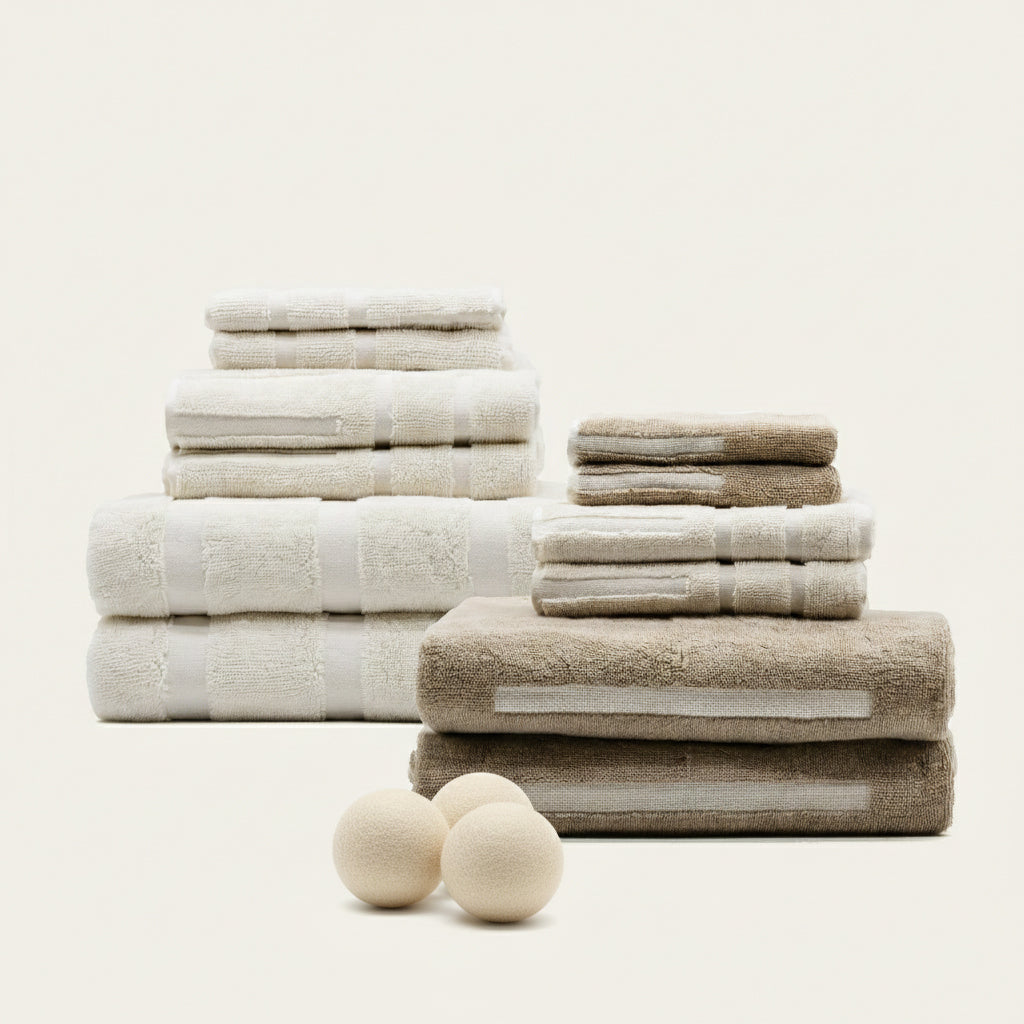 Stacks of beige and white towels on a light background
