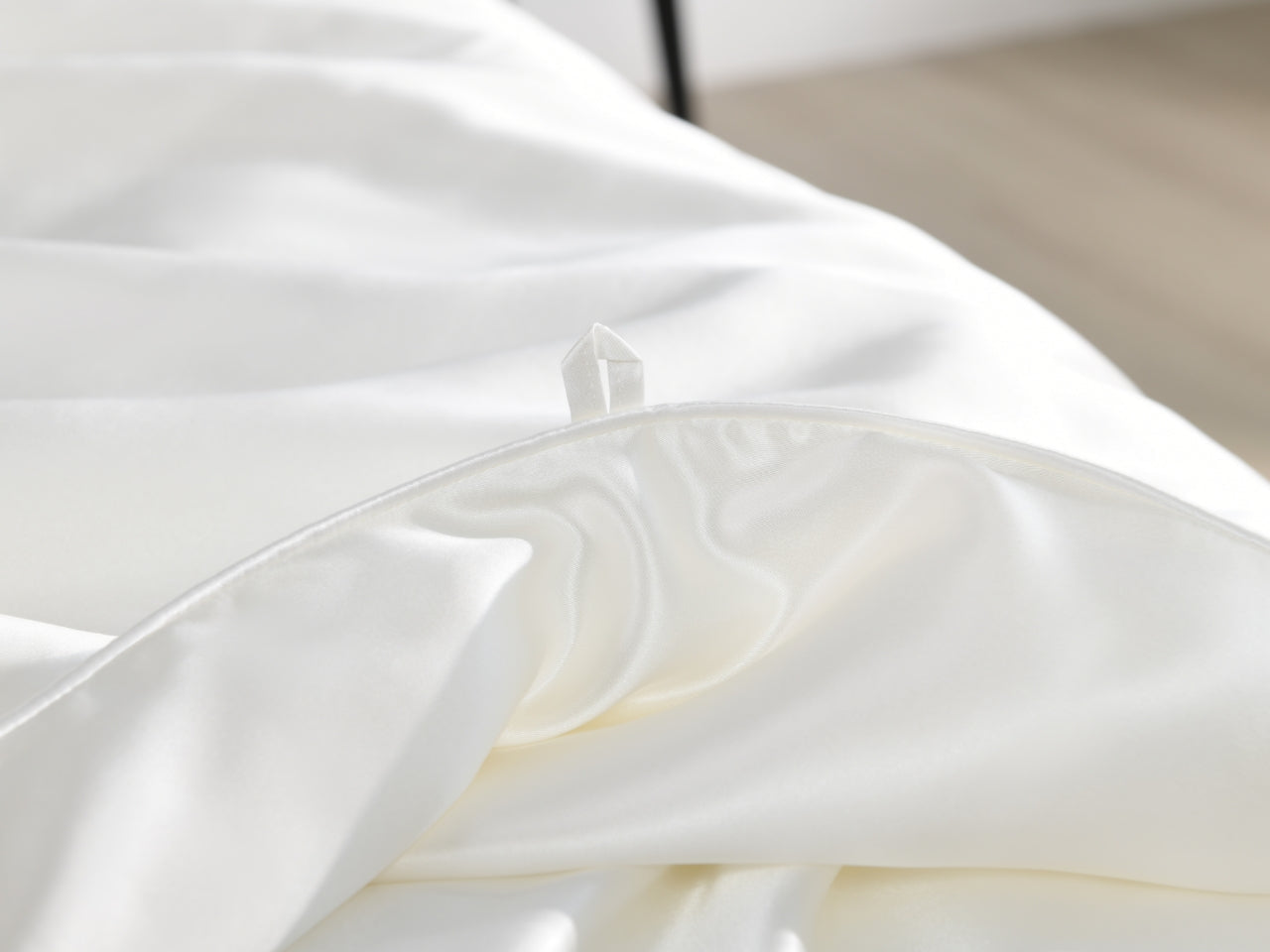 Close-up of white silk fabric with duvet hook closure