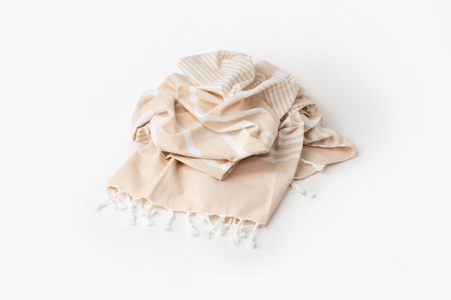 Beige towel with white stripes and tassels on a white background